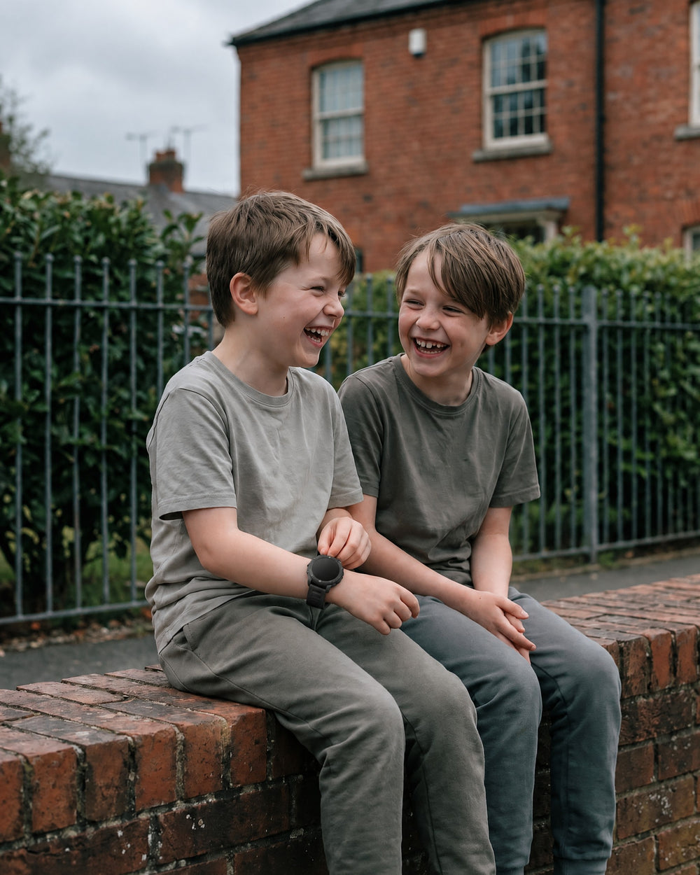 Two friends laughing on a wall, one wearing a Solvi Active