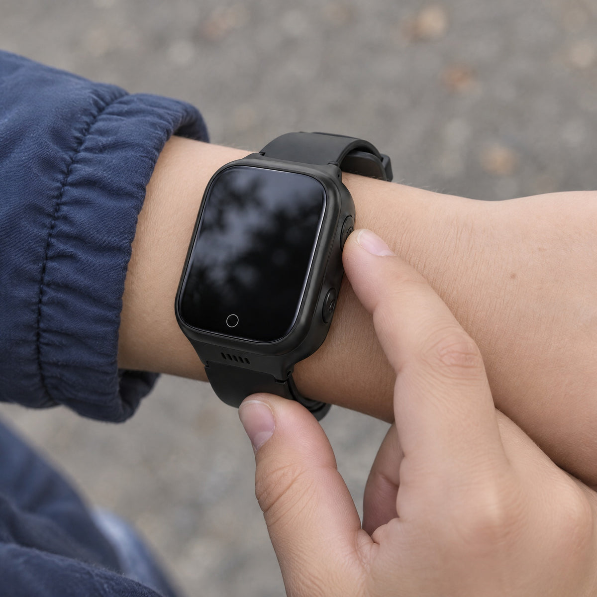 Solvi Max kids smartwatch in black on a child's wrist, outdoors