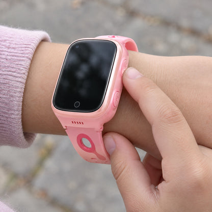 Solvi Max kids smartwatch in pink on a child's wrist, outdoors